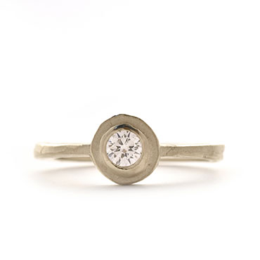 Engagement ring with diamond and round setting