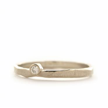 thin ring with off centered diamond