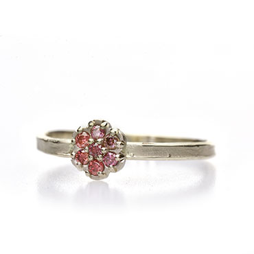 Ring with colored diamonds in flower setting