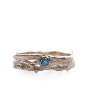 Golden ring with blue diamond