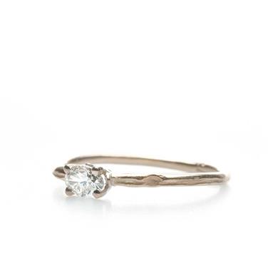 Narrow golden ring with oval diamond