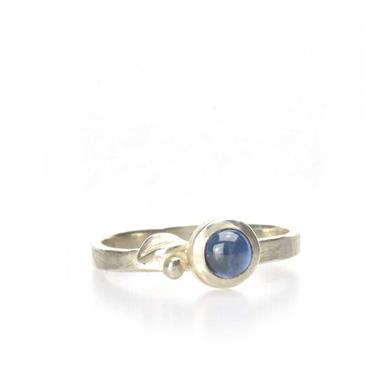 Ring with detail and blue sapphire