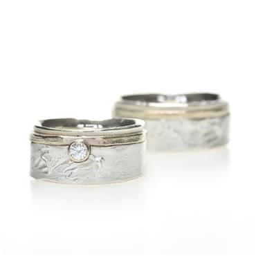 Silver wedding rings with detail in gold & diamond